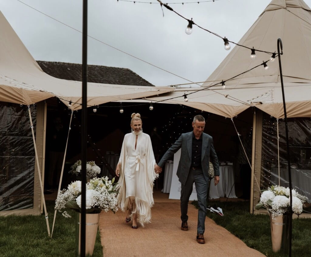 Married Couple Exiting A Tipi