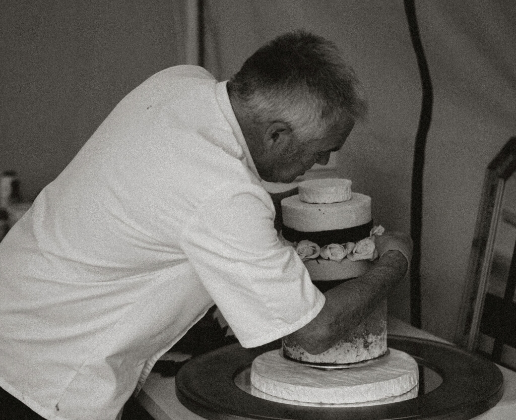 Chef Decorating A Wedding Cake