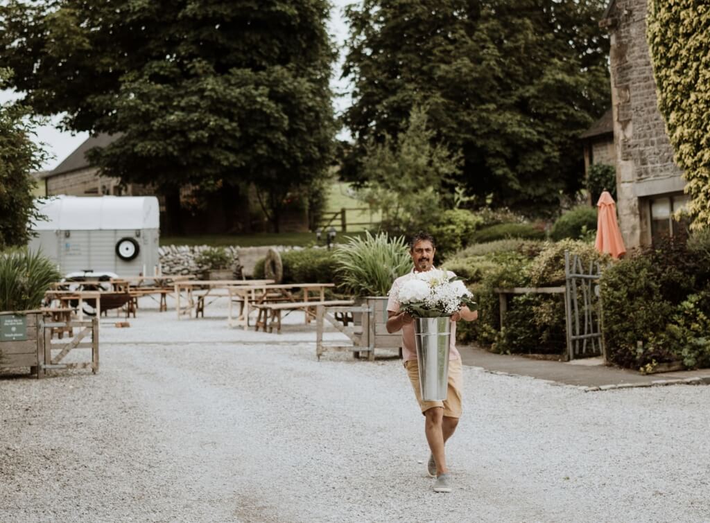 Man Carrying Flowers For A Wedding