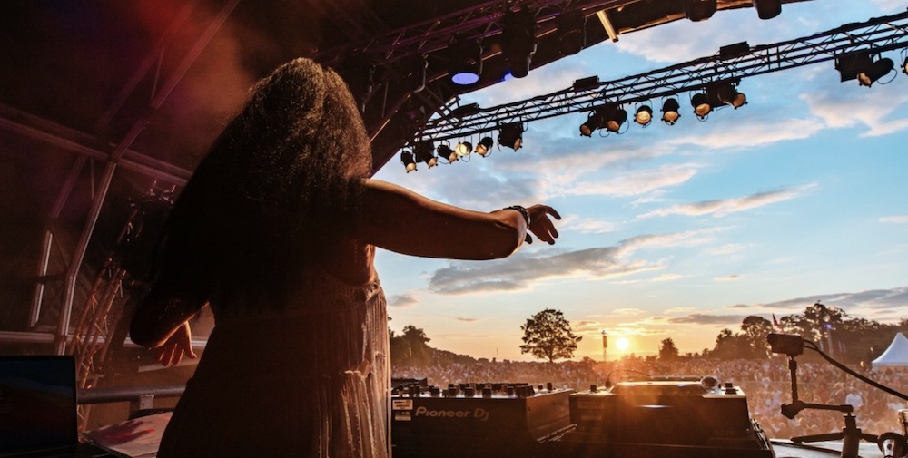 Female DJ Performs At Classic Ibiza On Stage Looking Out To The Audience.